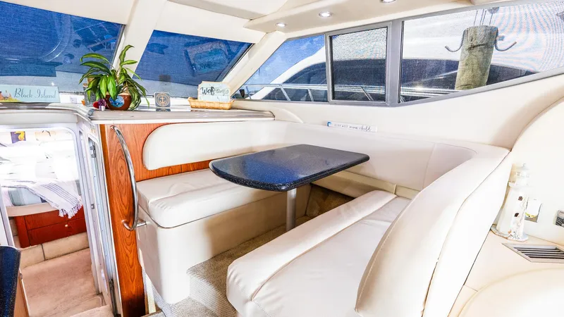 Knot On Call II Yacht Photos Pics Luxurious interior of 2000 Maxum 4600 SCB yacht with elegant seating and dining area.