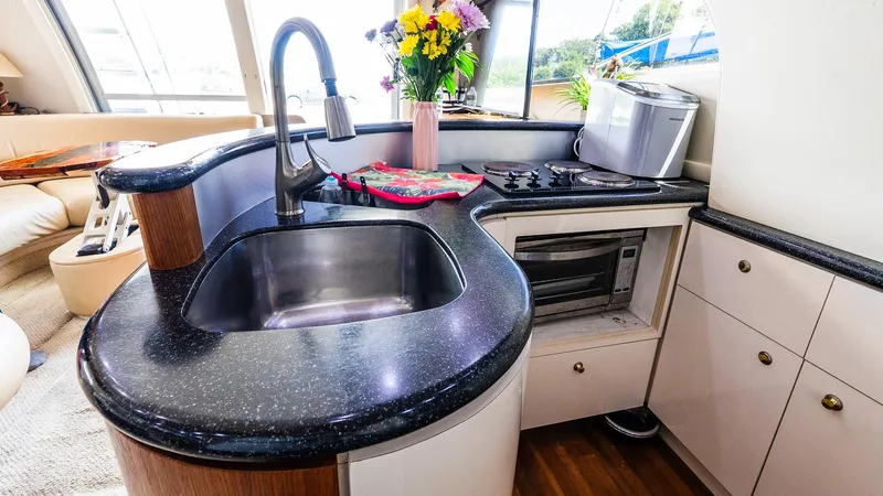 Knot On Call II Yacht Photos Pics Luxurious kitchen area in a 2000 Maxum 4600 SCB yacht with modern amenities.