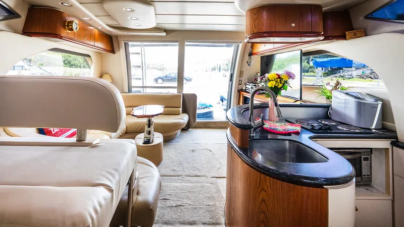 Knot On Call II Yacht Photos Pics Luxurious interior of 2000 Maxum 4600 SCB yacht with modern kitchen and seating area.