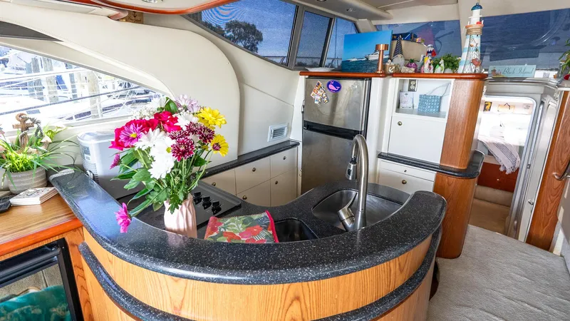 Knot On Call II Yacht Photos Pics Luxurious interior of 2000 Maxum 4600 SCB yacht with modern kitchen and floral decor.