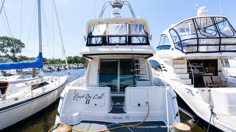 Knot On Call II Yacht Photos Pics 2000 Maxum 4600 SCB yacht docked, rear view, with neighboring boats in marina.