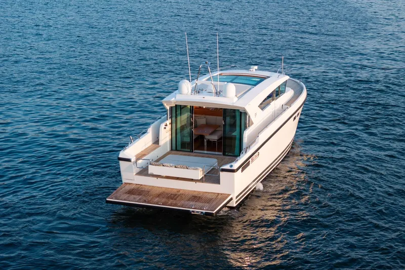  Yacht Photos Pics 2017 Delta Powerboats 54 IPS cruising on open water, rear view.