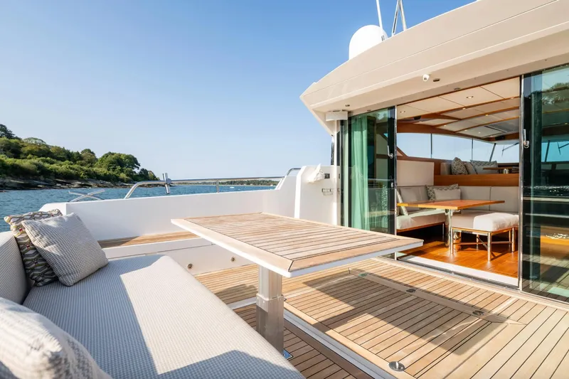  Yacht Photos Pics Luxurious 2017 Delta Powerboats 54 IPS yacht with elegant outdoor seating and scenic ocean view.