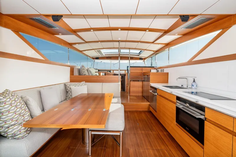  Yacht Photos Pics Luxurious interior of 2017 Delta Powerboats 54 IPS, featuring modern kitchen and dining area.