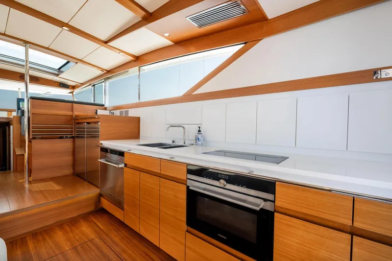  Yacht Photos Pics Luxurious kitchen interior of 2017 Delta Powerboats 54 IPS, featuring modern appliances and sleek wood finishes.