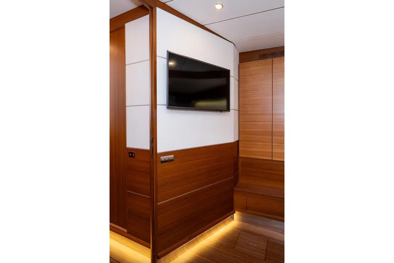  Yacht Photos Pics Luxurious interior of 2017 Delta Powerboats 54 IPS with modern wood paneling and wall-mounted TV.