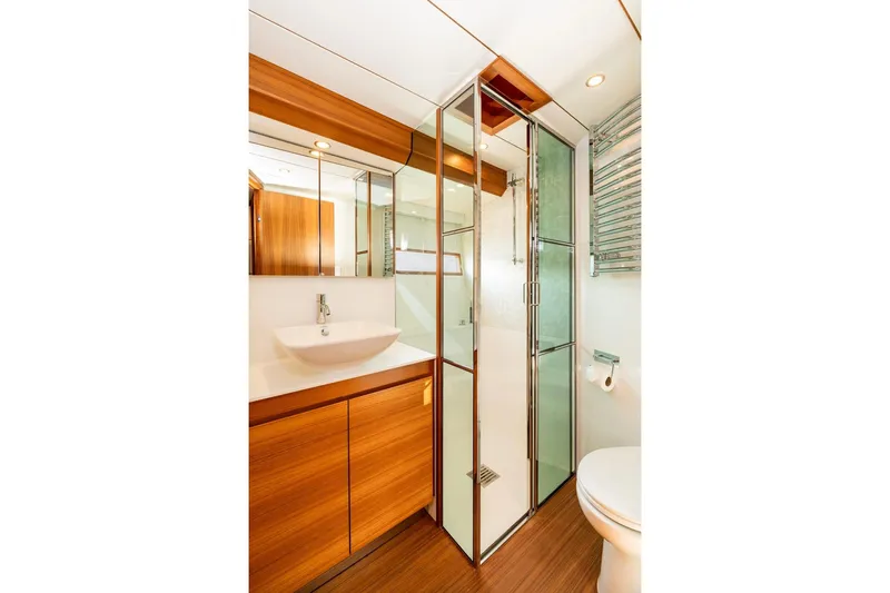  Yacht Photos Pics Luxurious bathroom in 2017 Delta Powerboats 54 IPS, featuring modern fixtures and wood accents.