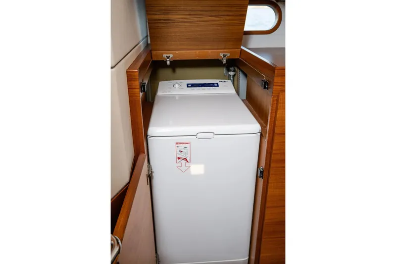  Yacht Photos Pics Washing machine in 2017 Delta Powerboats 54 IPS, wooden cabinet enclosure.