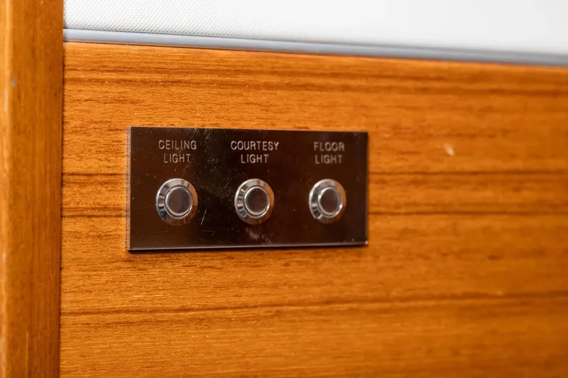  Yacht Photos Pics Light control panel on 2017 Delta Powerboats 54 IPS, featuring ceiling, courtesy, and floor light switches.