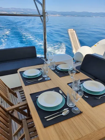  Yacht Photos Pics Dining setup on 2019 Lagoon 50 yacht with ocean view and elegant tableware.