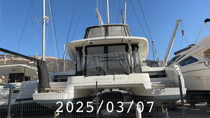  Yacht Photos Pics 2019 Lagoon 50 catamaran docked, viewed from the rear, with clear skies above.