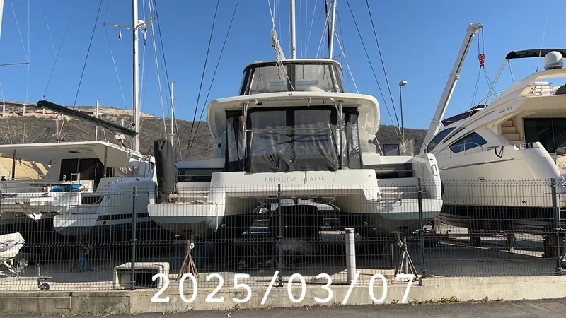  Yacht Photos Pics 2019 Lagoon 50 catamaran docked in a marina, viewed from the rear.