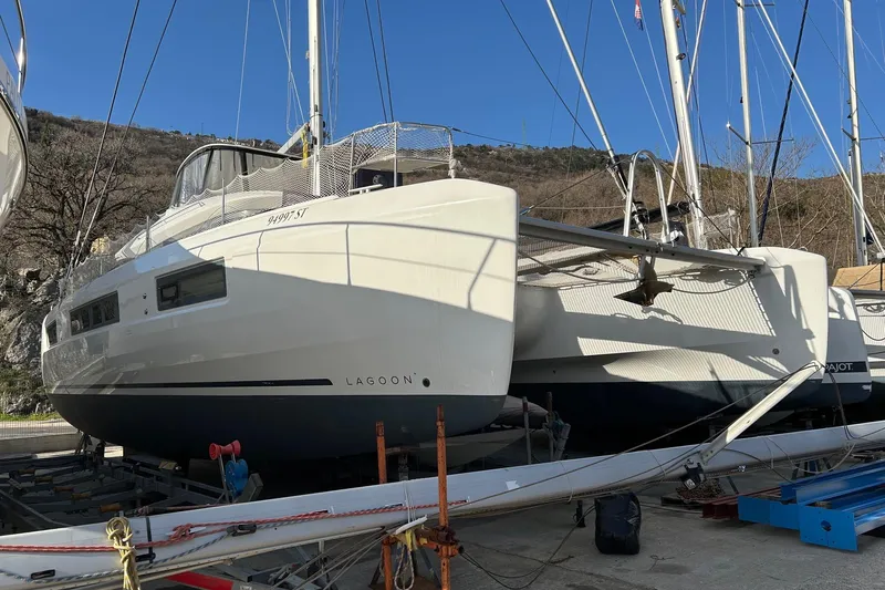  Yacht Photos Pics 2019 Lagoon LAGOON 50 catamaran docked on land, showcasing sleek design and modern features.