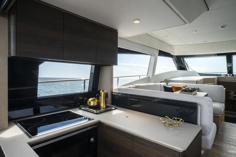  Yacht Photos Pics Luxurious interior of 2023 Ferretti Yachts 500, featuring modern kitchen and seating area.