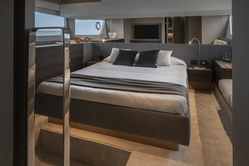  Yacht Photos Pics Luxurious bedroom interior of 2023 Ferretti Yachts 500, featuring modern design and elegant furnishings.