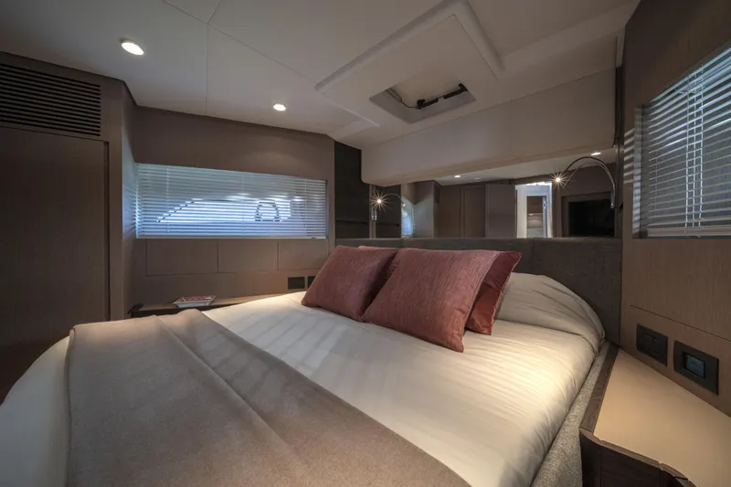  Yacht Photos Pics Luxurious bedroom interior of 2023 Ferretti Yachts 500, featuring elegant design and cozy ambiance.