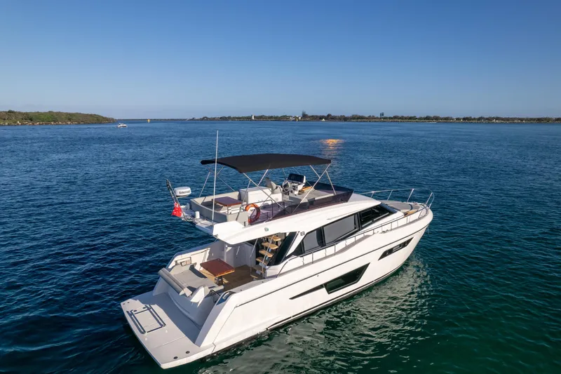  Yacht Photos Pics 2023 Ferretti Yachts 500 cruising on open water under clear blue sky.