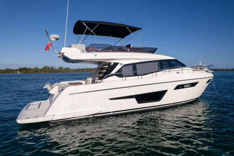  Yacht Photos Pics 2023 Ferretti Yachts 500 cruising on calm waters under clear blue sky.