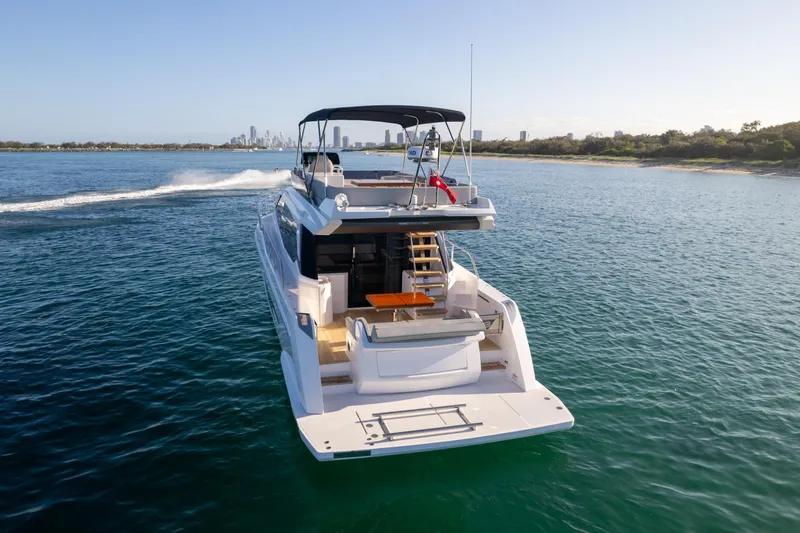  Yacht Photos Pics 2023 Ferretti Yachts 500 cruising on open water, showcasing luxury design and spacious deck.