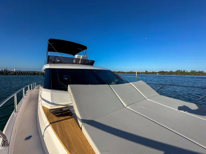  Yacht Photos Pics 2023 Ferretti Yachts 500 on calm water under clear blue sky.