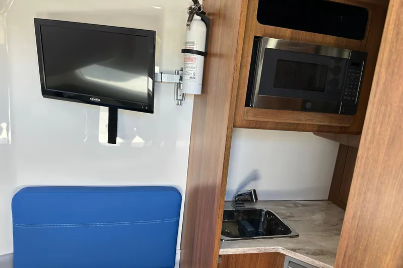  Yacht Photos Pics Interior of 2018 Invincible 42 boat with TV, microwave, and sink.