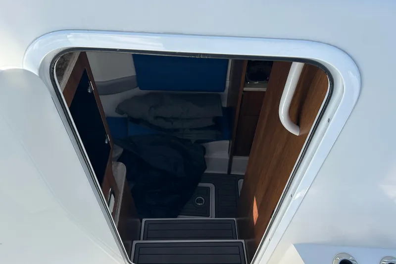  Yacht Photos Pics Interior cabin view of 2018 Invincible 42 boat, featuring wooden accents and seating.