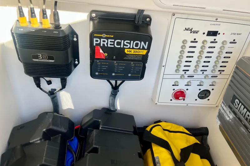  Yacht Photos Pics Control panel and equipment inside a 2018 SeaVee 270Z boat, featuring electronics and storage.