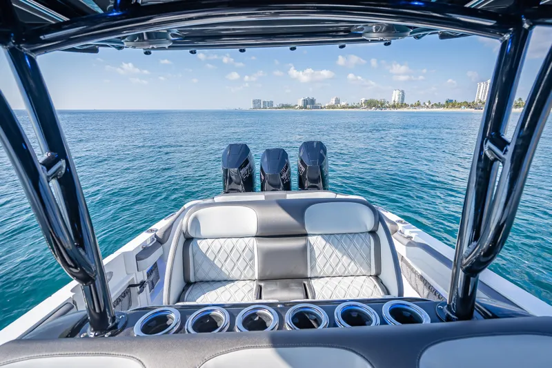  Yacht Photos Pics 2024 Nor-Tech 390 Sport Center Console on open water, showcasing luxury seating and powerful engines.