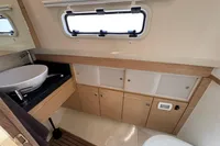 Modern bathroom interior of 2015 Fjord 40 Open yacht with sink, window, and storage cabinets.