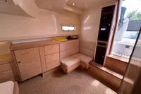 Luxurious interior of 2015 Fjord 40 Open yacht with wooden cabinetry and seating.