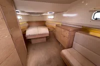 Luxurious interior of a 2015 Fjord 40 Open yacht with wood finish and cozy seating.
