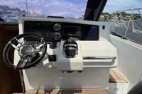 Helm of 2015 Fjord 40 Open yacht with modern controls and steering wheel.