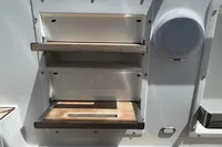 Fjord 40 Open 2015 boat interior with wooden shelves and speaker.