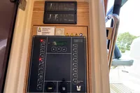 Control panel on a 2015 Fjord 40 Open yacht, featuring various switches and warning labels.