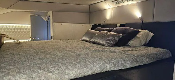  Yacht Photos Pics Luxurious bedroom interior of 2019 Sunreef 40 Open yacht with elegant bedding and ambient lighting.
