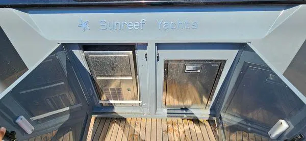  Yacht Photos Pics Sunreef 40 Open 2019 yacht deck with storage compartments and Sunreef Yachts branding.