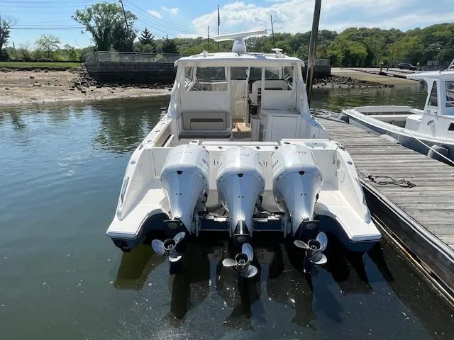  Yacht Photos Pics 2019 Pursuit DC 365 Dual Console boat with triple outboard engines docked at marina.
