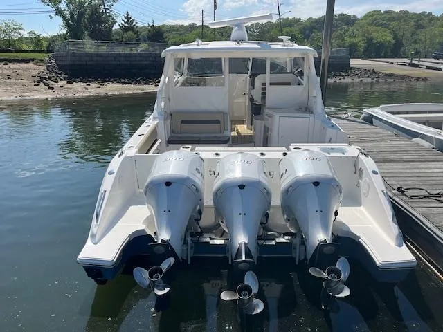  Yacht Photos Pics 2019 Pursuit DC 365 Dual Console boat with triple outboard engines docked at a marina.