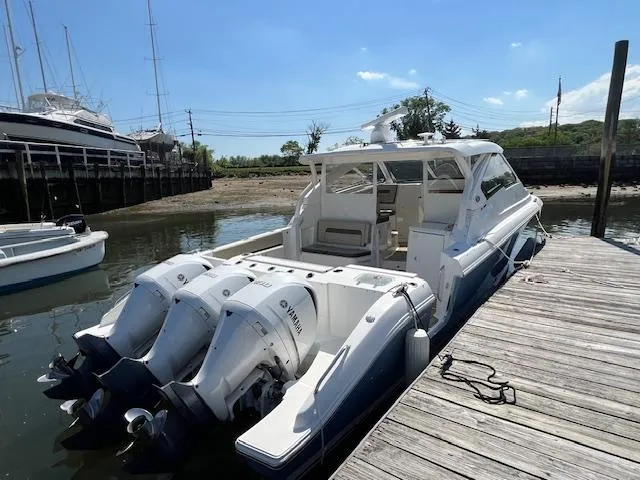  Yacht Photos Pics 2019 Pursuit DC 365 Dual Console boat docked with triple Yamaha outboard engines.