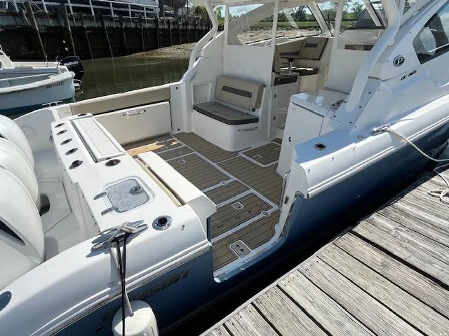  Yacht Photos Pics 2019 Pursuit DC 365 Dual Console boat docked, featuring spacious seating and sleek design.