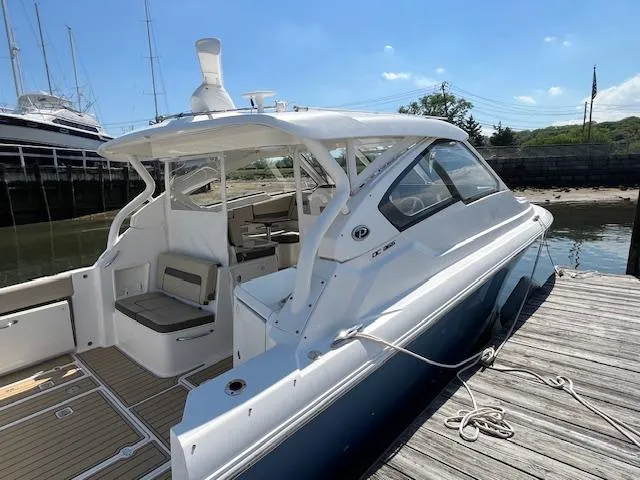  Yacht Photos Pics 2019 Pursuit DC 365 Dual Console boat docked, showcasing sleek design and spacious seating.