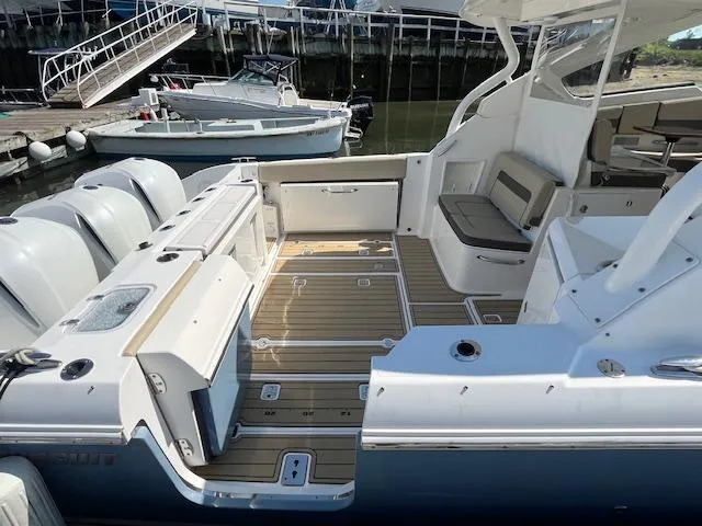  Yacht Photos Pics 2019 Pursuit DC 365 Dual Console boat with spacious deck and seating at a marina.