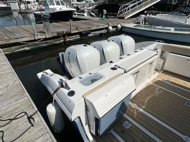  Yacht Photos Pics 2019 Pursuit DC 365 Dual Console boat docked with triple Yamaha outboard engines.