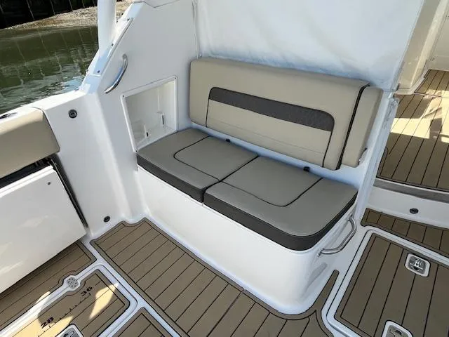  Yacht Photos Pics 2019 Pursuit DC 365 Dual Console boat seating with beige cushions and teak flooring.