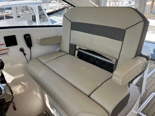  Yacht Photos Pics 2019 Pursuit DC 365 Dual Console boat interior with beige seating and armrests.