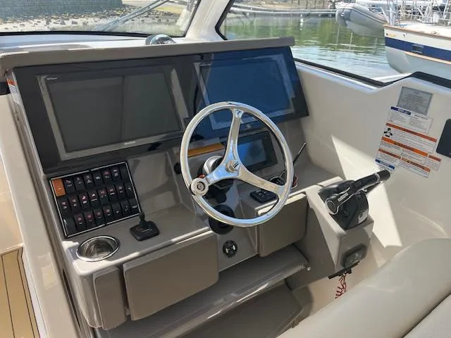  Yacht Photos Pics 2019 Pursuit DC 365 Dual Console helm with steering wheel and control panel.