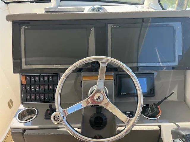  Yacht Photos Pics 2019 Pursuit DC 365 Dual Console dashboard with steering wheel and electronic displays.