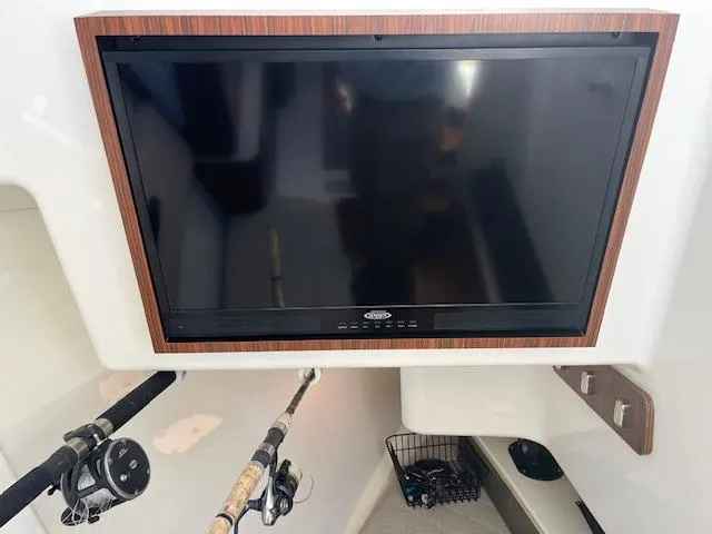  Yacht Photos Pics 2019 Pursuit DC 365 Dual Console interior with mounted TV and fishing rods.
