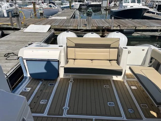  Yacht Photos Pics 2019 Pursuit DC 365 Dual Console boat interior with seating and deck at marina.