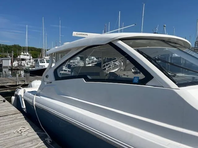  Yacht Photos Pics 2019 Pursuit DC 365 Dual Console boat docked at marina under clear blue sky.